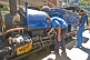 Image of A passenger watches the engineer make adjustments to a steam locomotive on the Darjeeling Himalayan Railway.