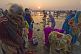Image of Women pilgrims prepare for ritual bathing in Ganges river at dawn.