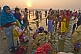 Image of Male and female pilgrims prepare for ritual bathing in Ganges river at dawn.