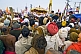 Image of Hindu crowds block road to see Basant Panchami Snana procession at Kumbh Mela.
