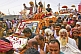 Image of Mass crowds of Hindu Holy Men and jeeps block the Kumbh Mela procession road.