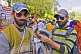 Two young men sell false beards and moustaches to Kumbh Mela pilgrim visitors.