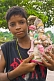 Small Boy Holds A Statue Of Lakshmi, Wife Of Vishnu And Goddess Of Wealth, That Was Found In The River Mud