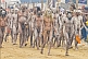 Image of Ash-smeared Naga Holy Men walk in procession from Ganges river bathing ceremony.