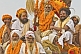 Group of Hindu Holy Men decorated with marigolds on processional truck roof.