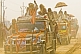 Decorated Hindu trucks create thick dust clouds in Basant Panchami Snana procession.