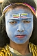 Village boy with blue Shiva face paint at Kumbh Mela Hindu festival.