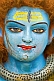 Image of Cracked blue face of clay statue of god Shiva at Kumbh Mela Hindu religious festival.