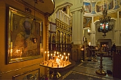 Candle light illuminates an ancient gilded icon in the Zenkov Cathedral.