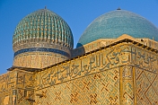 Blue tiled domes and caligraphy-covered walls of the Yasaui Mausoleum.