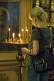 Image of Worshipper lighting candles in front of icon at Saint Nicholas Cathedral.