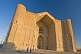 Frontage of the Yasaui Mausoleum in early morning sunlight.