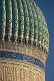 Blue tiled dome of the Yasaui Mausoleum in the evening sunlight.