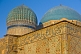 Image of Blue tiled domes and caligraphy-covered walls of the Yasaui Mausoleum.