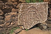 Carved stone christian plaque at the ruins of the San Ignacio Mission.