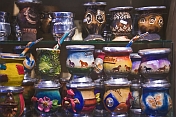 Selection of colorful pottery mate cups for sale.