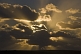 Image of Sun shines through clouds on the Bahia Camarones.
