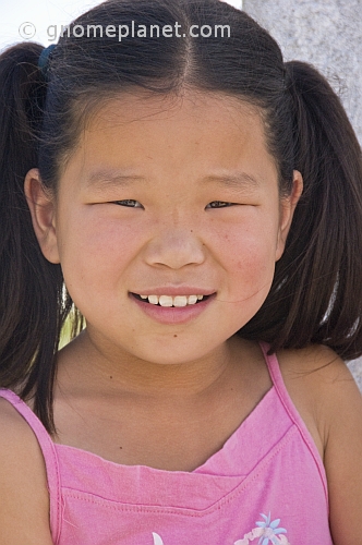 Young Mongolian girl in pink top.