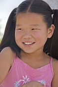 caption: Young Mongolian girl in pink top.