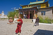 A Buddhist monk carries food to a service in the Gandan Muntsaglan Khiid monastery.