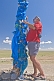 Image of Tying a blue prayer scarf on an 'Ovoo', a Mongolian Shamanistic cairn for travellers.