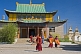 Image of Monks hurry to a service in the Gandan Muntsaglan Khiid monastery.