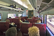 Passengers and seating in Indian Pacific Red Class carriage.