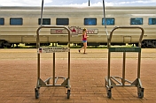 Young tourist in shorts walk past 'Ghan' carriages