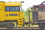 Yellow GSR Cv40-9i locomotive and car transporter at Alice Springs railway station.