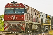 The Ghan's red locomotive clears the points at Alice Springs