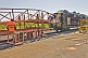 Image of Attendant unloads vehicles from the car transporter carriage on the Ghan train.