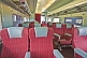 Empty red and gray Day-Nighter seats in Ghan Red Class carriage.
