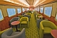 Image of Tables and armchairs in the Red Gum Lounge Car of the Ghan long distance train.