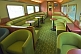 Image of Tables and seating in the Red Gum Lounge Car of the Ghan long distance train.