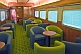 Image of Tables and armchairs in the Red Gum Lounge Car of the Ghan long distance train.