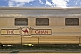 Ghan train signboard and stainless steel carriages at Alice Springs railway station.