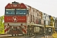 Image of Cv40-9i railway locomotive pulls the Ghan train out of Alice Springs station.