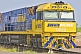 Image of Yellow and blue Ghan locomotive waiting at Alice Springs railway station.