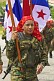 A female soldier from Panama's National Defense Forces holds the national flag of Panama aloft.