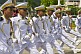 Soldier-recruits with drawn sabres march in slow-time formation down the Avienda Balboa, in Panama City.