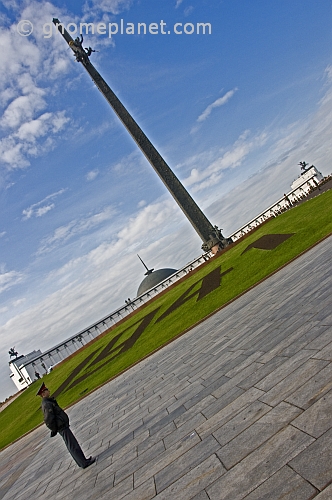 A Russian policeman patrols in front of the 142m Obelisk in Victory Park, near the Museum of the Great Patriotic War.