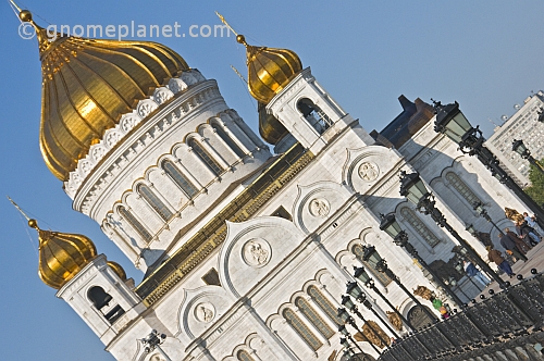 The gold-domed Cathedral of Christ the Saviour stands next to the Moscow River.