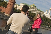 Russian tourists photographing in front of the Kremlin, on the Moscow River .