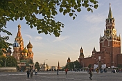 Crowds wander past St. Basils Cathedral and across Red Square in the evening sunshine.