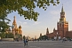 Crowds wander past St. Basils Cathedral and across Red Square in the evening sunshine.