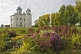 Image of Cathedral of St George at the Yurev Monastery, set in a colourful garden of flowers.