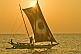 'Oruwa' outrigger fishing boat in calm seas at sunset