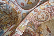 Desecrated Christian paintings in an ancient church carved out of a cave.