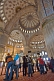 Tourist group views the domed interior of the Sultan Ahmet Camii, the Blue Mosque, in Sultanahmet.