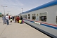 Image of Rail travellers board the Dashogus Express at Ashgabat Station.